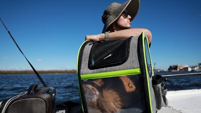 Xavier Pinero and his cat are taken off the island in Florida. Getty / AFP