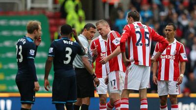 Stoke’s Ryan Shawcross, centre, appeals to referee Andre Marriner after being sent off against Tottenham yesterday. Alex Livesey / Getty Images