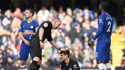 Referee Kevin Friend pats Chelsea goalkeeper Kepa Arrizabalaga on the head. Getty
