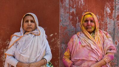 Onima, 60, poses for photographs before and after celebrating Holi in Vrindavan.