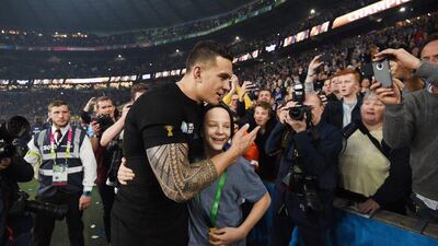 New Zealand's Sonny Bill Williams gives his 2015 Rugby World Cup winner's medal to a fan. EPA