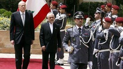 The Lebanese prime minister Najib Mikati, left, with the Iranian first vice president Mohammad Reza Rahimi, centre. Mohamad Azakir / Reuters