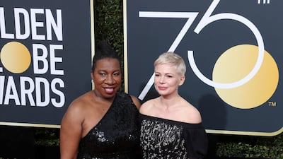 Michelle Williams, in black Louis Vuitton, and Tarana Burke at the 75th annual Golden Globe Awards in Beverly Hills, California on January 7, 2018. EPA