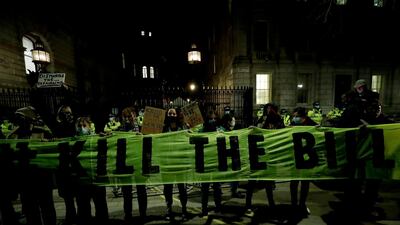 People hold up a banner against the British government's proposed crime bill during a march in London. AP Photo