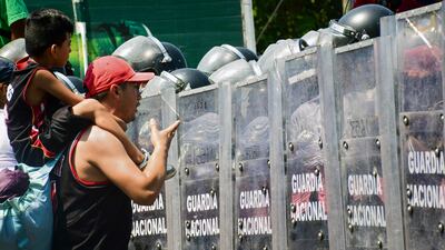 Members of the National Guard block migrants in Tapachula, Mexico, as they try to walk en masse to the capital to gain residency status. AFP