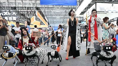 Robot dogs are walked by a woman dressed as 101 Dalmatians villain Cruella de Vil at the World Robot Conference in Beijing, China. AFP