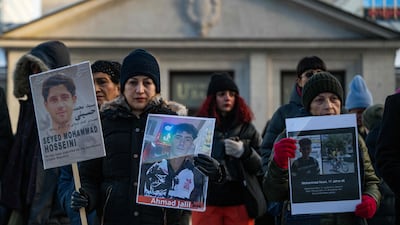 Protesters display placards featuring portraits of Iranians executed by the Iranian regime, during a rally in Berlin, Germany, on Saturday. AFP