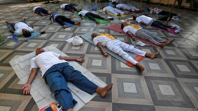 People perform yoga outside a residential house in Ahmedabad. Reuters