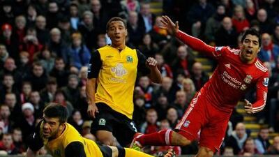 Liverpool’s misfiring striker Luis Suarez, right, watches another shot fly wide against Blackburn Rovers at Anfield on Monday.