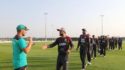 Rohan Mustafa, UAE captain, and Aaron Finch, captain of Australia, shake hands at the end of the match.