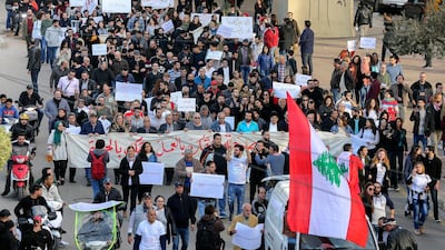 Lebanese activists from the civil society hold placards and carry banners with reading 'We will not pay the price' as they chant slogans against corrupt politicians during a protest in front the Ministry of Labor in the southern suburb of Beirut. EPA