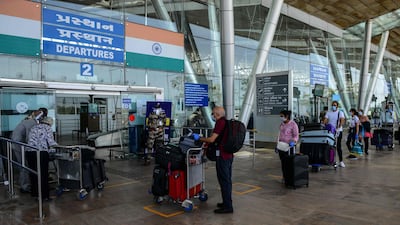 British nationals queue up outside a departures terminal before boarding a special British Airways flight at the Sardar Vallabhbhai Patel International (SVPI) airport in Ahmedabad. AFP