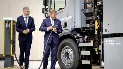 King Willem-Alexander of the Netherlands, right, charges an electric lorry at the opening of a test lab in Arnhem. AFP