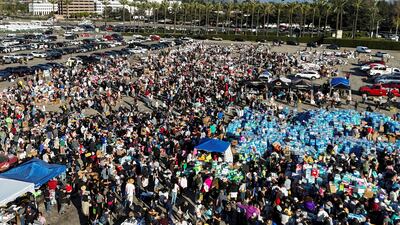An aerial image shows people affected by the wildfires gathering at a donation centre, at the Santa Anita Park race track in Arcadia. Reuters