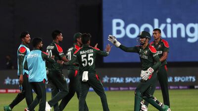 Bangladesh's Mustafizur Rahman, second left, celebrates with teammates after taking a catch of Oman's captain Zeeshan Maqsood. AP