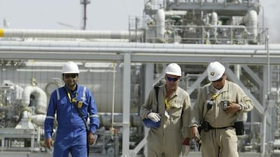 Above, Royal Dutch Shell workers walk through the Majnoon oilfield in Basra. Essam Al Sudani / Reuters
