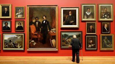 A visitor to Te Papa Museum looks at an exhibition of portraits in Wellington, New Zealand. Mark Baker / AP Photo