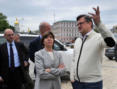 Ukrainian Foreign Minister Dmytro Kuleba speaks with French Foreign Minister Catherine Colonna at the memorial wall in Kyiv in May. AFP