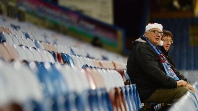 Burnley supporters take their seats at Turf Moor on Tuesday prior to their team's 1-1 draw with Newcastle United in the Premier League. Jamie McDonald / Getty Images