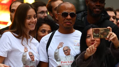Onlookers await the arrival of Pope Leo at the Cathedral of the Holy Spirit. EPA