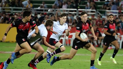 Dubai English Speaking College (black) on their way to victory over Dubai College in the Gulf Under 19 boys cup final at The Sevens on the second day of the Emirates Dubai Rugby Sevens on December 3, 2021. DESC won the match 36-14 on. All photos Pawan Singh / The National