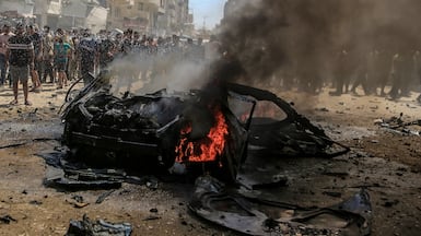 The wreckage of a car burns after an Israeli strike on Gaza city. EPA