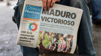 A Venezuelan newspaper carries a front-page report on the re-election of President Nicolas Maduro on May 21, 2018. Luis Robayo / AFP