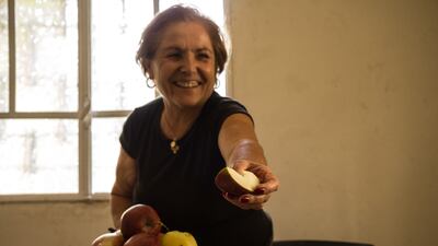 Therese Comair offers apples grown in her orchard in the village of Tannourine, an hour-and-a-half’s drive north-east of Beirut. Picture: Elizabeth Fitt