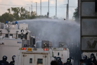 Police use water cannon on protesters. Reuters