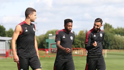 Diogo Dalot, Fred, Bruno Fernandes of Manchester United in action during a first team training session at Carrington Training Ground in Manchester, England.