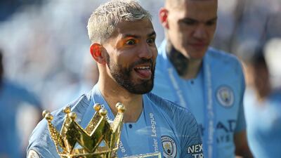 Manchester City's Sergio Aguero celebrates with the Premier League trophy after the match against Brighton and Hove Albion in May 2019. EPA