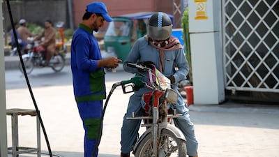 Refuelling at a petrol station in Peshawar, Pakistan. EPA