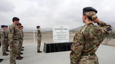 British servicemen and women stand to attention during a memorial service for Sgt William Henry Donnelly, who died on February 14, 1943 when his Wellington bomber crashed in Fujairah. Pawan Singh / The National