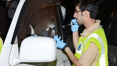 A forensics expert from Sharjah Police inspects a vehicle in the Al Qassimiyah area of Sharjah where police found the child.