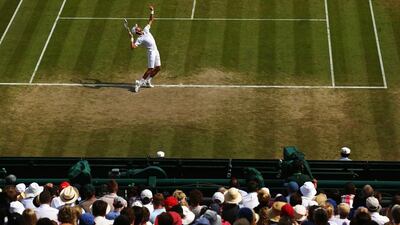 Novak Djokovic serves during his singles match against Marin Cilic on Wednesday at the 2014 Wimbledon Championships quarter-finals. Djokovic beat Cilic in five sets after going 2-1 sets down. Clive Brunskill / Getty Images