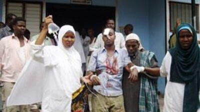 A Somali journalist wounded in the explosion is assisted by nurses outside Madina hospital in Mogadishu.