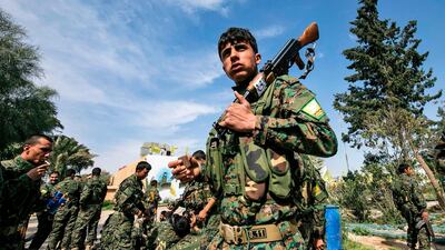 Fighters of the US-backed Kurdish-led Syrian Democratic Forces (SDF) celebrate near the Omar oil field in the eastern Syrian Deir Ezzor province on March 23, 2019, after announcing the total elimination of ISIS. AFP