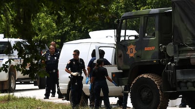 Police investigators check the van containing the six members of the the Saldivar family who died after they crashed their van into Greens Bayou, trying tried to flee Hurricane Harvey during heavy flooding in Houston, Texas