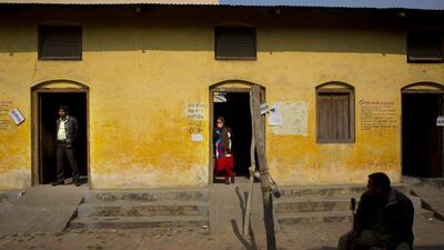 A security guard sits outside a polling station in Moradabad, Uttar Pradesh, India. Manish Swarup / AP Photo