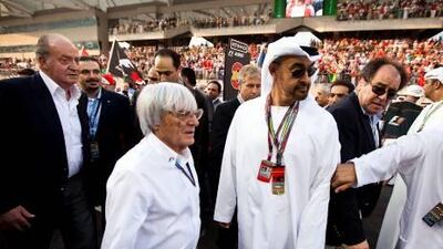 His Highness General Sheikh Mohammed bin Zayed, Crown Prince of Abu Dhabi, Deputy Supreme Commander of the UAE Armed Forces, walks with Bernie Ecclestone on the starting grid prior to the start of the Abu Dhabi Grand Prix at Yas Marina Circuit in Abu Dhabi on Sunday. On the left are King Juan Carlos of Spain and Saad Hariri, the prime minister of Lebanon.