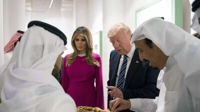 The Trumps are offered dates and sweets at Murabba Palace. SPA / EPA