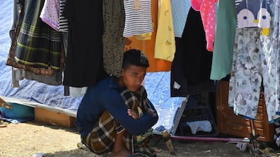 An Indonesian man looks on from the shade during Friday prayers. AFP