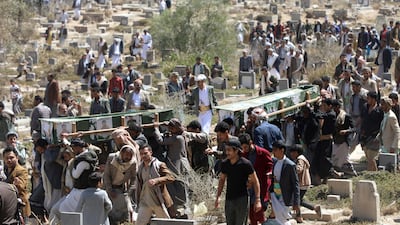 Mourners bury the victims of US air strikes at Al Mashhad Cemetery in Sanaa, Yemen, on Wednesday. AP
