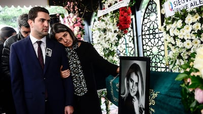 Relatives of Burcu Gundogar Urfali comfort each other. AFP