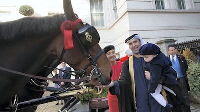 His Excellency Mansoor Abulhoul following his visit with Her Majesty The Queen at Buckingham Palace for the presentation of diplomatic credentials. Seen here with his wife in red with black hat, Victoria Devin and the Assistant Marshal of the Diplomatic corps with feathers in hat. Outside the Lanesborough Hotel in central London where the reception HE Mansoor Abdulhoul's Vin d'honneur took place.