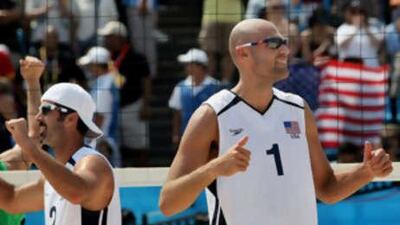 Todd Rogers, left, celebrates with his teammate Philip Dalhausser after their victory over Germany's David Klemperer and Eric Koreng in the men's quarter-final beach volleyball