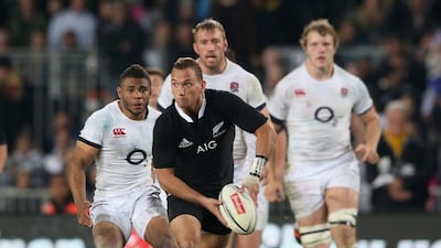 Aaron Cruden, centre, of New Zealand passes the ball during the Test against England at Eden Park in Auckland on June 7, 2014. David Rogers / Getty Images
