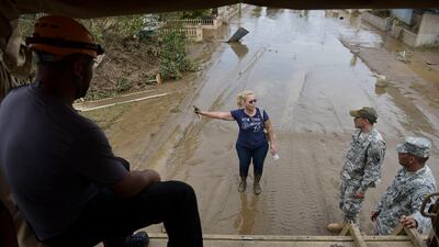National Guard personnel offer evacuation to a Toa Ville resident on September 22, 2017 amid fears the Rio La Plata Dam was about to collapse after the heavy rains brought by Hurricane Maria. Carlos Giusti / AP