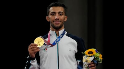 Iran's Mohammedreza Geraei on the podium after winning gold in the men's 67kg Greco-Roman wrestling.
