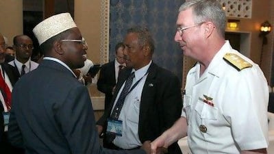 Somalia president Sheikh Sharif Sheikh Ahmed shakes hands with US Vice Adm. John W. Miller, commander of the fifth fleet, at an international anti-piracy conference in Dubai last June. He has been accused of shielding a top pirate commander from arrest.